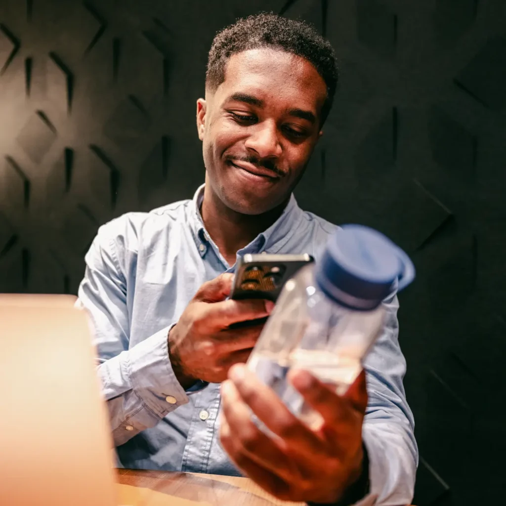 A person holding a Cupanion bottle scanning it with their phone
